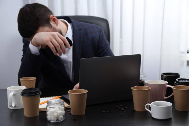 Professional desk showing hidden energy drains during the workday