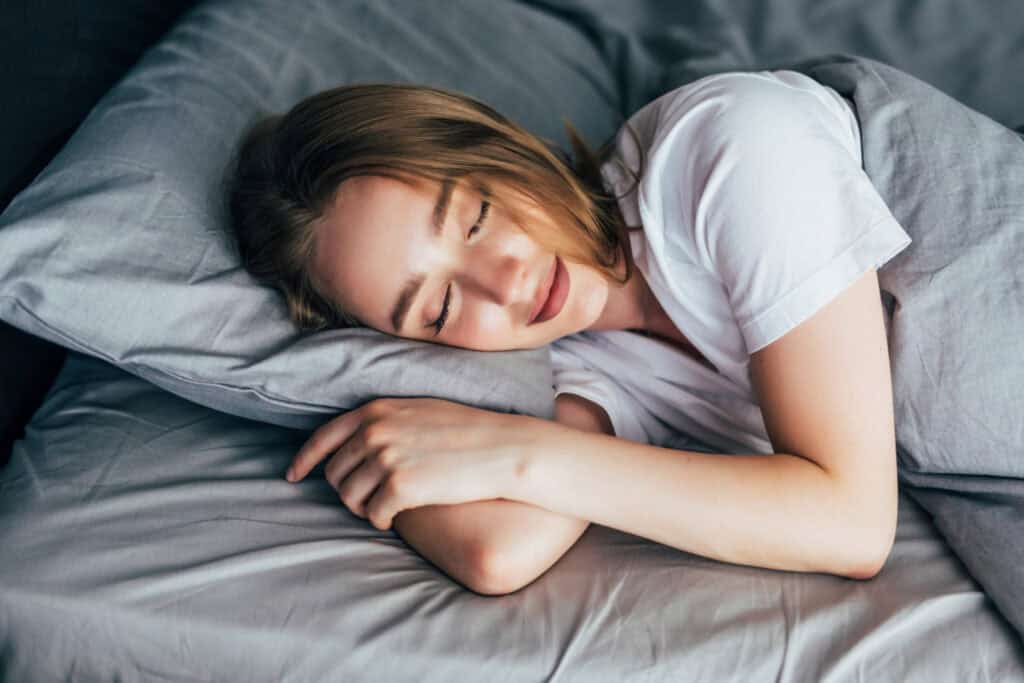 Professional over 40 resting in bed for proper sleep and recovery.