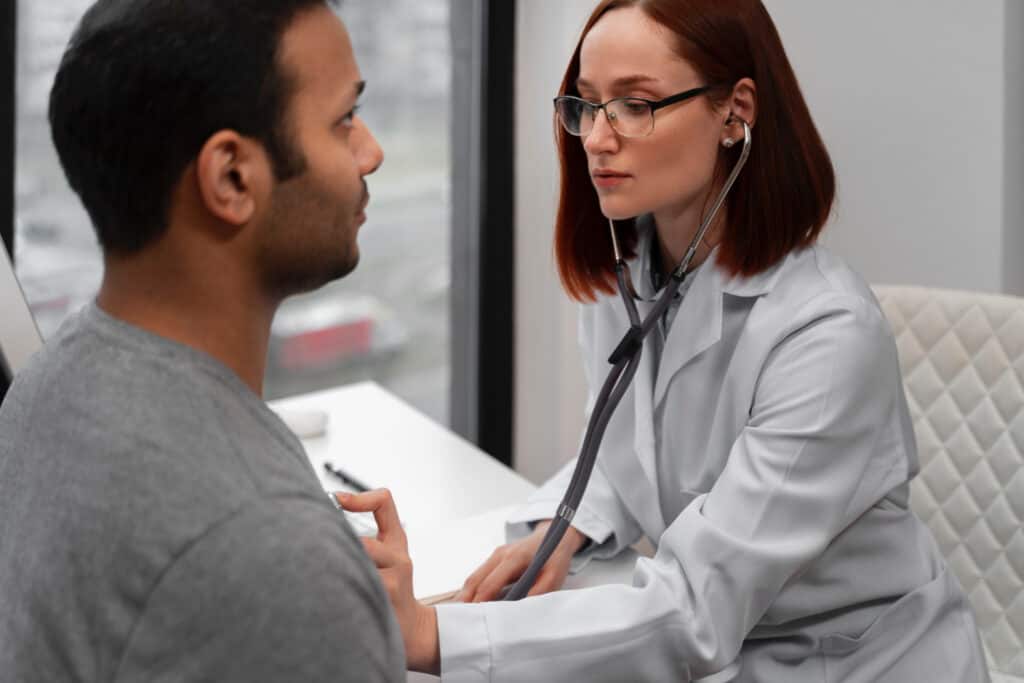 Professional over 40 undergoing preventive health screening with doctor.